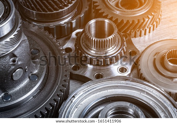 Set of various engine and gearbox spare\
parts. Shiny gears for planetary gearbox.Metal  autotechnology\
background. wheel engine gears, close\
up
