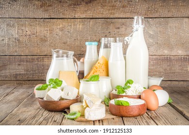 Set of Various Fresh Dairy Products - milk, cottage cheese, cheese, eggs, yogurt, sour cream, butter on wooden background - Shutterstock ID 1912125133