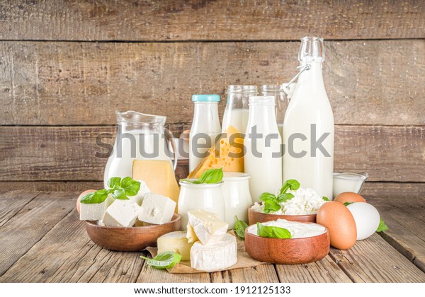 Set\
of Various Fresh Dairy Products - milk, cottage cheese, cheese,\
eggs, yogurt, sour cream, butter on wooden\
background
