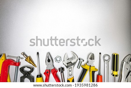 set of various hand work tools for construction and renovation job on metal desk. top view, copy space