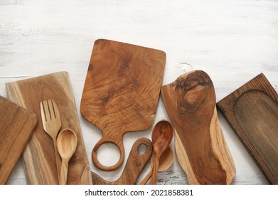 Set of various kitchen utensils - wood cutting boards, spoons and fork on rustic white wooden background. Top view, flat lay. - Shutterstock ID 2021858381