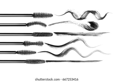 Set of various mascara brushes with mascara strokes on white background