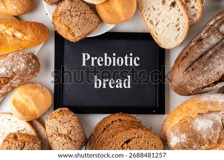 Set of various Prebiotic Bread with live bacteria, prebiotics, fiber for gut health. Healthy alternative to regular bread, different rye, white, grain bread and buns on white table background