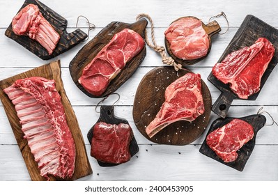 Set of various raw meat steaks. Fresh meat of beef, pork, veal, chicken, steak t-bone, rib eye, tomahawk, ribs, tenderloin on cutting board over white background. Meat food, butcher shop, top view - Powered by Shutterstock