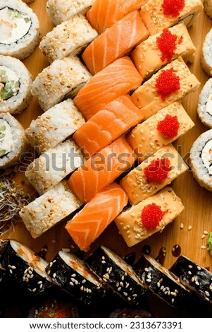 Set of various rolls with tuna, salmon, eel, avocado, cucumber, tobiko calve. Big sushi set. Japanese food.
