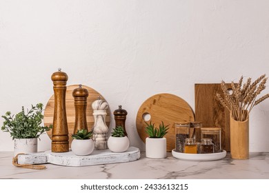 Set of various spice mills and glass jars with seasoning on white marble countertop. Stylish kitchen background in light colors. . Front view. - Powered by Shutterstock