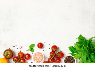 Set of vegetables, herbs and spices on white marble background top view. Recipe book cover concept.