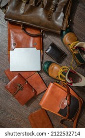 A Set Of Vintage Brown Leather Every Day Use Man Accessorys: A Briefcase, Messenger Bag, Tramp Shoes, A Purse, Notebook And A Notepad With A Handmade Leather Binding, And A Laptop. Top View (flat-lay)