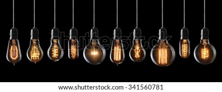 Set of vintage glowing light bulbs on black background