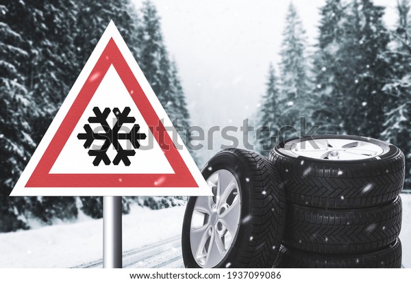 Set of\
wheels with winter tires and road sign\
outdoors