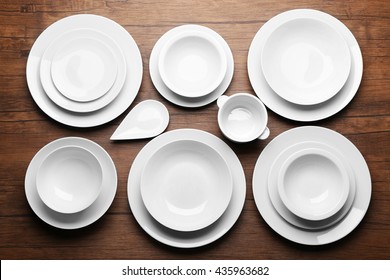 Set Of White Dishes On Wooden Background