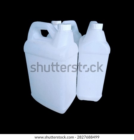 Set of white plastic jerrycans grouped together isolated on a solid black background
