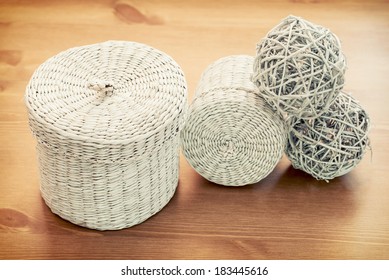 Set Of White Seagrass Basket On A Wooden Table.