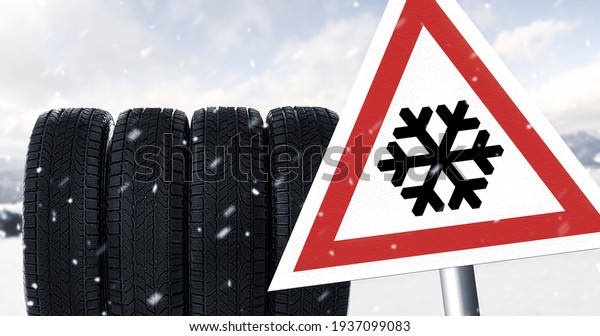 Set of winter\
tires and road sign\
outdoors
