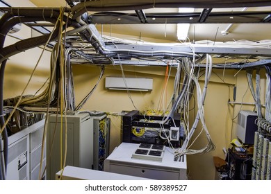 
A Set Of Wires And Cables Intertwined In Data Center Server Room. Top View Of The Control Room