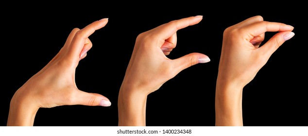 Set Of Woman Hands Holding Something With Two Fingers On Black Background. Isolated With Clipping Path.