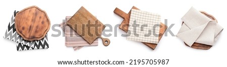 Set of wooden boards and napkins on white background, top view