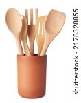 Set of wooden kitchen utensils, spoon, fork and spatula, in a terracotta container, isolated on white background