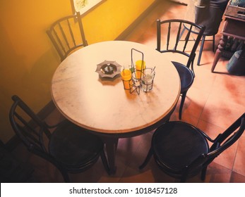 Set Of Wooden Round Old Chairs And Marble Table At Retro Coffee Shop In Thailand, Vintage Filter Effect. Top View.