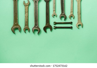 Set of wrenches on a mint background. Space for text