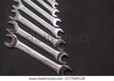 Set of wrenches tool. Different sizes on black with copy space. Industrial background.