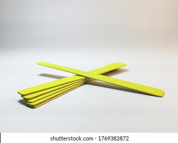 Set yellow disposable nail files gray gradient background  Tools for independent manicure   pedicure  nail care  Space for your text logo  Selective focus 