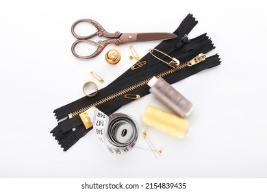 Set Of Zippers And Sewing Supplies On White Background