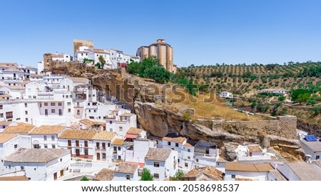 Setenil de las Bodegas, rustic village with cave houses on a sunny day with blue sky, in the province of Cadiz, Andalusia, Spain.