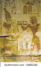 Seti Making An Offering To The Ancient Egyptian God Osiris.  Temple Of Osiris, Abydos, Egypt.  The Tray Of Food Being Proffered Looks Suspiciously Like Cupcakes.
