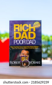 Setif, Algeria - June 9, 2021: Close Up Robert Kiyosaki And Sharon Lechter's Rich Dad Poor Dad Book And Book Keychain. Entrepreneurship Concept.