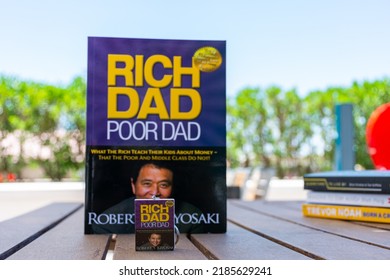 Setif, Algeria - June 9, 2021: Close Up Robert Kiyosaki And Sharon Lechter's Rich Dad Poor Dad Book And Book Keychain. Entrepreneurship Concept.