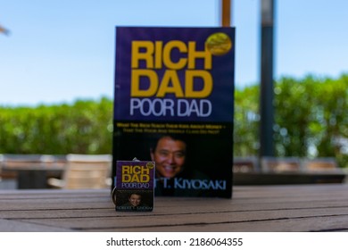 Setif, Algeria - June 9, 2021: Close Up Robert Kiyosaki And Sharon Lechter's Rich Dad Poor Dad Book And Book Keychain. Entrepreneurship Concept.