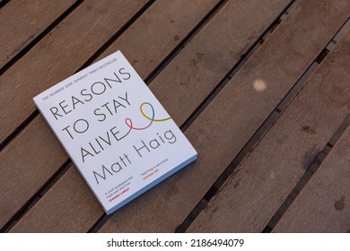 Setif, Algeria - June 9, 2021: Close Up Matt Haig's Reasons To Stay Alive Novel On A Wooden Table.