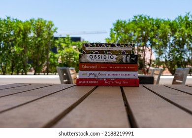 Setif, Algeria - June 9, 2021: Close Up A Stack Of Books On The Wooden Table Outside. New Arrivals Books Concept.