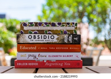 Setif, Algeria - June 9, 2021: Close Up A Stack Of Books On The Wooden Table Outside. New Arrivals Books Concept.