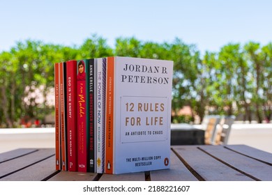 Setif, Algeria - June 9, 2021: Close Up A Stack Of Books On The Wooden Table Outside. New Arrivals Books Concept.