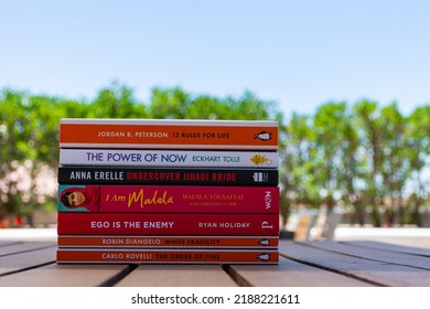 Setif, Algeria - June 9, 2021: Close Up A Stack Of Books On The Wooden Table Outside. New Arrivals Books Concept.