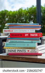 Setif, Algeria - October 24, 2021: Close Up A Stack Of Books On The Wooden Table Outside. New Arrivals Books Concept.