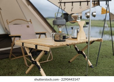 sets of camping equipment in the form of tents and camping tables as well as equipment for making portable coffee in the open and in sunny weather - Powered by Shutterstock