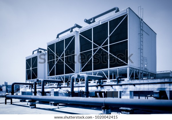 Sets of\
cooling towers in data center\
building.
