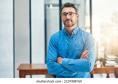 Setting the bar as a leader. Portrait of a mature businessman standing in an office. - Powered by Shutterstock