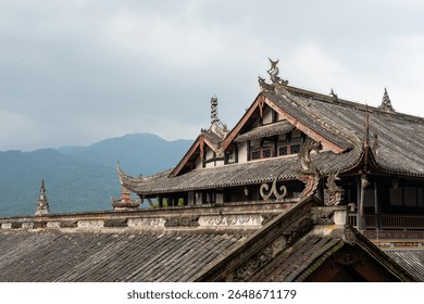The setting captures the unique architectural features of traditional buildings in DuJiangYan, Sichuan province, China. The roofs display intricate designs and symbolic figures, reflecting the rich