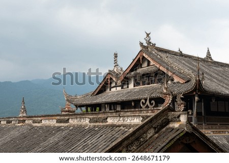 The setting captures the unique architectural features of traditional buildings in DuJiangYan, Sichuan province, China. The roofs display intricate designs and symbolic figures, reflecting the rich