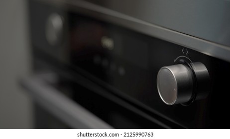 Setting cook modes and oven temperature. Cooking, baking. LCD display of kitchen appliances. White numbers and symbols on a black background. Woman turning switch button, turn on.