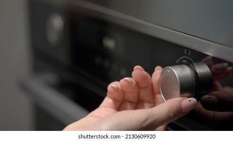 Setting cook modes and oven temperature. Cooking, baking. LCD display of kitchen appliances. White numbers and symbols on a black background. Woman turning switch button, turn on. - Shutterstock ID 2130609920