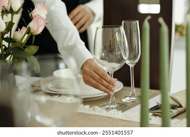 Setting Elegant Dinner Table With Wine Glasses
