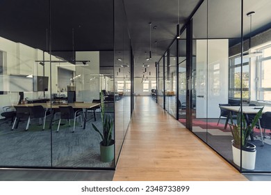 In a setting of modern, glass-walled business startup offices, the open, airy workspace reflects a contemporary and innovative ambiance, promising a dynamic environment for entrepreneurial growth