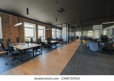 In a setting of modern, glass-walled business startup offices, the open, airy workspace reflects a contemporary and innovative ambiance, promising a dynamic environment for entrepreneurial growth