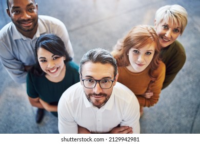 Setting Our Sights On Higher Goals. High Angle Portrait Of A Team Of Colleagues Standing Together In A Modern Office.