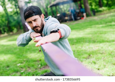 Setting up slacklining equipment before performing crazy slacklining tricks in the park